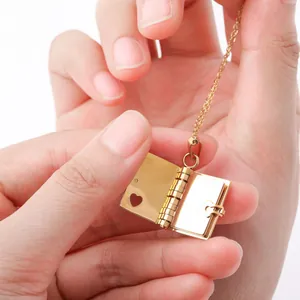 Close-up of golden book-shaped locket necklace with inner heart cutout detail