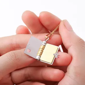 Macro view of a mini book-shaped pendant with a gold interior and heart-shaped hollow