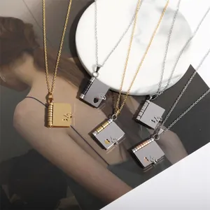 Titanium steel book locket pendant necklace with heart cutout and gold plating