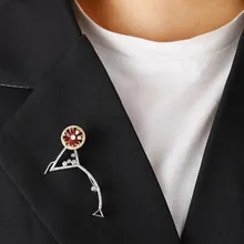 Macro shot of a martini glass brooch with red zircon stones on a black suit lapel