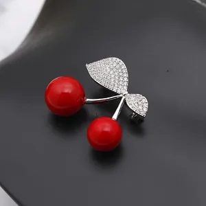 Sparkling cherry brooch with red enamel fruit and cubic zirconia inlaid silver leaves