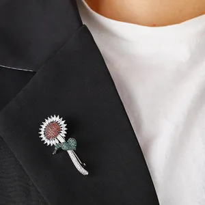 Elegant sunflower brooch with colorful crystals pinned on a black suit lapel blazer