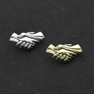Spille retrò a forma di stretta di mano in finitura argento e bronzo per coppie