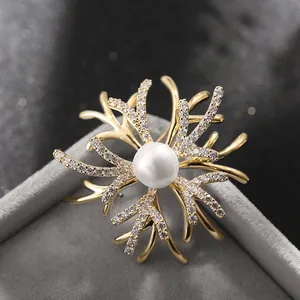 Elegant gold coral branch brooch with a large white pearl and sparkling crystals
