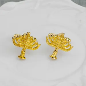 Golden Menorah cufflinks for men's shirts displayed on a white embossed ceramic plate