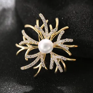 Elegant gold coral branch brooch with central white pearl and sparkling zircons