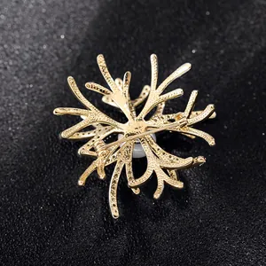 Detail of coral-shaped gold pin with pearl accent and secure back clasp mechanism