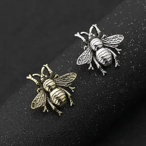 Detail van vintage bijenvormige broches in antiek zilver en brons metaal met reliëftextuur