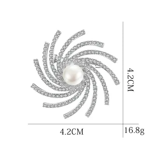 Sparkling rotating snowflake brooch with central pearl and rhinestones 4.2cm diameter