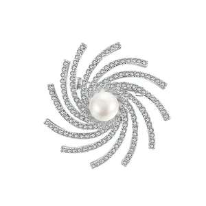 Rotating snowflake brooch with large center pearl and sparkling cubic zirconia stones