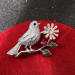 Elegant bird on branch brooch with sparkling zircons and colorful enamel details