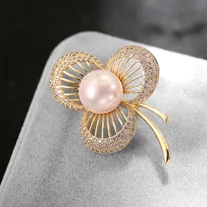 Spilla a trifoglio dorata con perla rosa ed intarsio di cristalli di zircone
