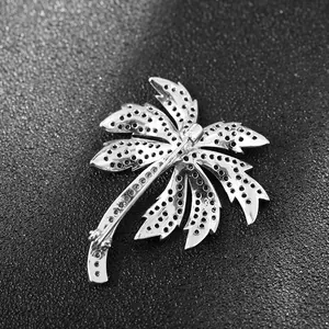 Polished silver coconut tree brooch with detailed back honeycomb structure and pin clasp