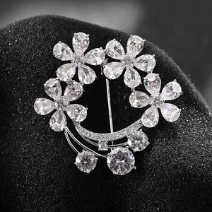 Elegant silver floral moon brooch featuring pear-cut rhinestones and crystal charms