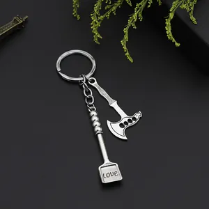 Creative metal keychain with miniature axe and love engraved shovel on a black background