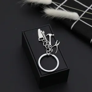 Mini silver metal keychain featuring miniature saw, wrench, hammer and plier tools