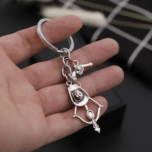 Western cowboy style silver alloy keychain featuring a revolver, hat and bow charm