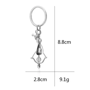 Creative silver alloy keychain with cowboy hat and revolver charms measuring 8.8 cm