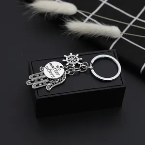 Silver Hamsa Hand and steering wheel keychain with engraved 'no matter where' pendant