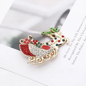 Detailed macro shot of a gold-plated reindeer sleigh brooch with festive rhinestones