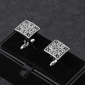 Detailed macro view of square vintage cufflink pair in elegant black velvet gift box