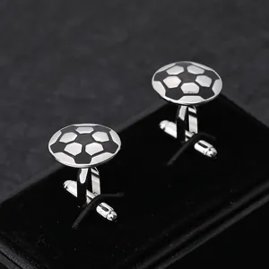 Close-up of silver soccer ball cufflinks with bullet back in a black velvet gift box