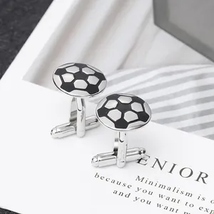 Polished silver football cufflinks with black and white enamel on a minimalist card
