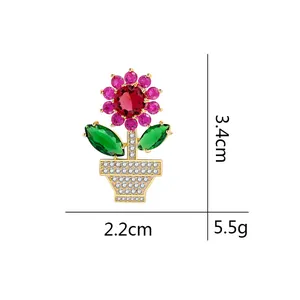 Sunflower brooch with pink gemstones and red center stone on golden base measuring 3.4cm