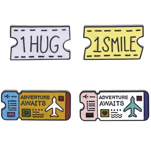 Set of four colorful enamel lapel pins with Adventure Awaits and ticket designs
