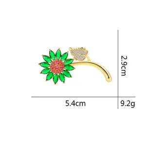 Elegant sunflower brooch with green petal stones, gold-tone stem and white crystals