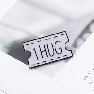 Detailed macro view of a vintage enamel airplane ticket brooch featuring 1 HUG engraved text