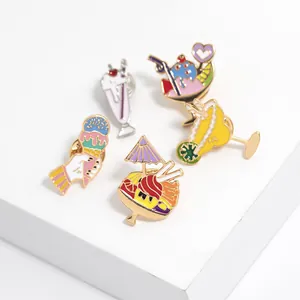 Detail of five cute summer dessert enamel pins with pastel ice cream and cold drink designs