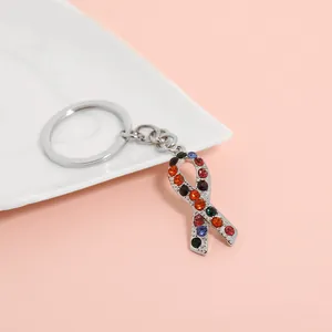 Detailed close-up of rainbow rhinestone ribbon keychain in silver alloy metal finish