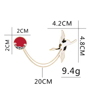 Japanese style cartoon crane brooch with red sun disc and elegant gold chains