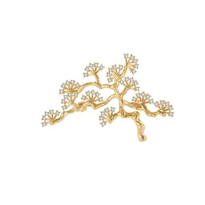 Elegant gold pine tree branch brooch with sparkling white crystals for women fashion