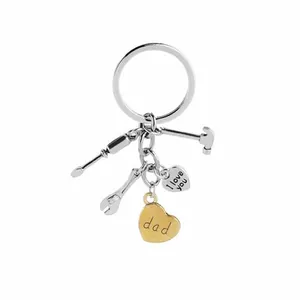 Detail of metal keychain with tools and heart charms engraved with I love you dad