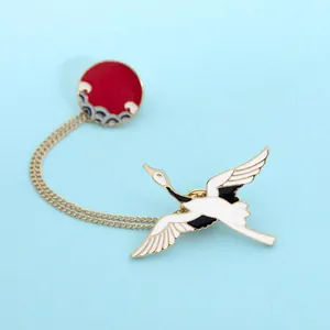 Japanese style crane enamel brooch with red sun and wave pendant on blue background
