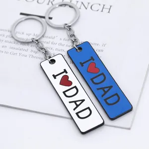 Detail of blue and white metal keychains with I Love Dad engraving and red heart icon