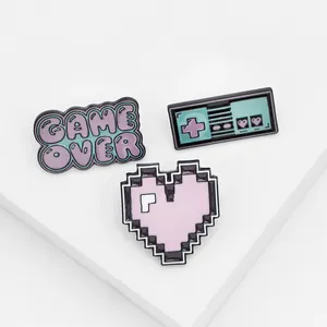 Three-piece retro enamel pins set featuring a heart, game controller, and GAME OVER text