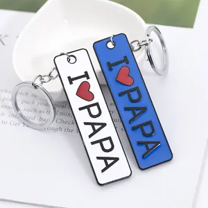 Detailed macro view of Father's Day metal keychains with I LOVE PAPA engraving