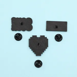 Macro detail of the matte black alloy metal badge backs with anti-slip grid texture