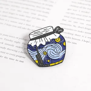 Artistic Van Gogh Starry Night enamel brooch in a bottle shape on a vintage book background