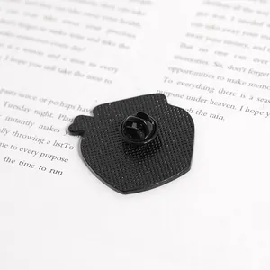 Detailed back view of a black enamel pin featuring a textured finish and butterfly clasp