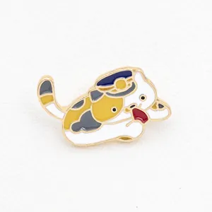 Cute cartoon calico cat enamel pin wearing a blue uniform hat with golden metal edges
