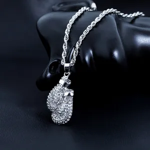 Macro shot of silver boxing gloves pendant with white stones on a rope chain