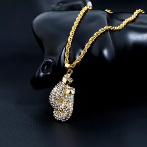 Detailed close-up of hiphop gold boxing glove pendant with sparkling zircon inlays