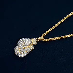 Close-up of hip-hop boxing glove pendant with sparkling cubic zirconia on gold twist chain