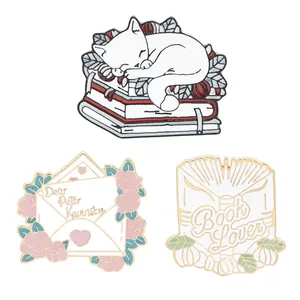 Three-piece set of enamel pins with cute cats, letters, and books for backpacks