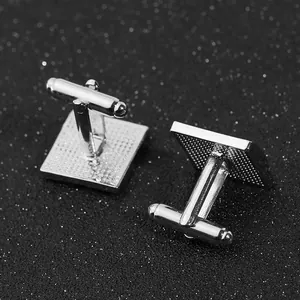 Close-up of square silver cufflinks with textured back and T-bar swivel closure