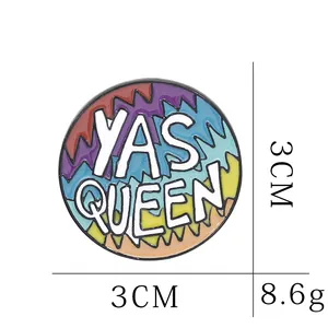 Detail view of round enamel Yas Queen brooch showing 3cm diameter and 8.6g weight